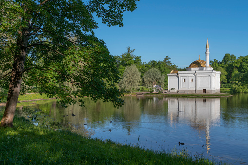 The pavilion of the Turkish Bath on the shore of a Large pond in the Catherine Park in Tsarskoye Selo on a sunny summer day, Pushkin, St. Petersburg, Russia