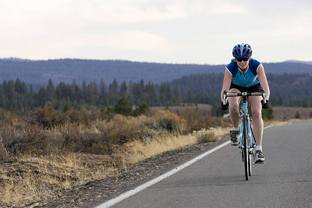female cycling on a flat road
