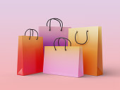 Set of glossy shopping bags in gradient colors on a sweet pastel background, 3d render illustration with clipping path