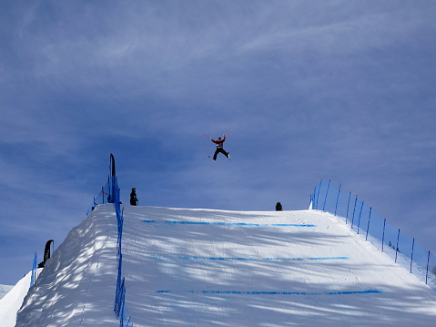 Aspen, Colorado, USA- February 11, 2023: Skier getting big air on a jump at Buttermilk ski resort, Aspen, Colorado.