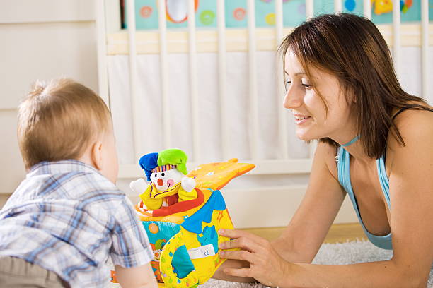 istock Baby playing with a Jack-in-the-Box with his mother 146749862