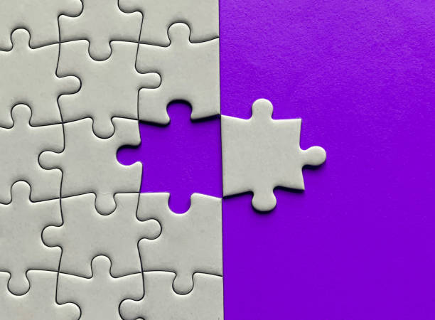 istock Top view of missing jigsaw puzzle with customizable space for text on maroon color background. Copy space concept. 1467498902
