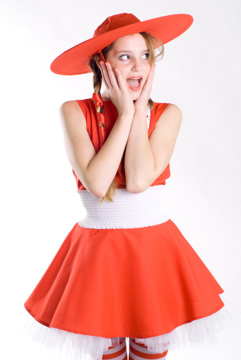 Surprised girl in red hat posing mouth open