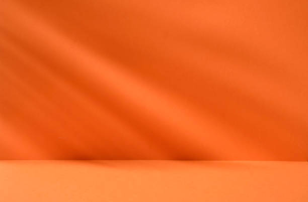 istock Bright orange background with plant shadows for product or cosmetics 1467504369