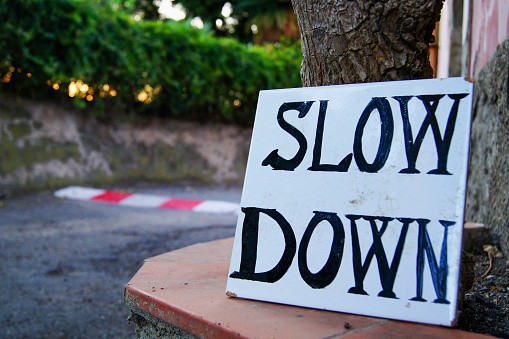 Homemade slow down sign on tile.