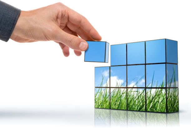 A hand placing the final cube to complete a picture stock photo