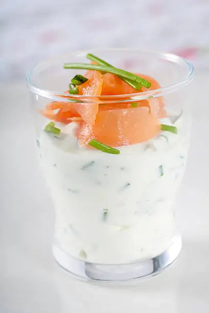 Small and healthy appetizer with smoked salmon and creamcheese decorated with chives