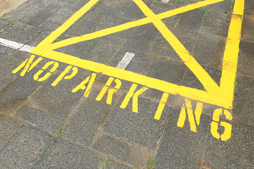 no parking sign on road black in singapore .