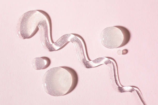 istock Cosmetic lotion transparent gel drops texture background, pink 1467515272