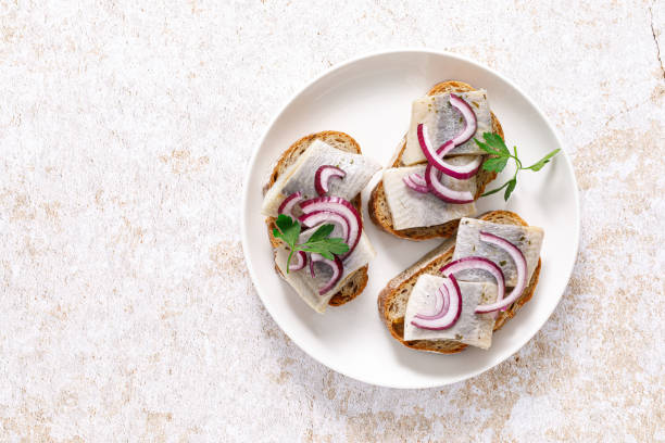 istock Herring sandwich. Toast with bread, herring and onion. Top view 1467517326