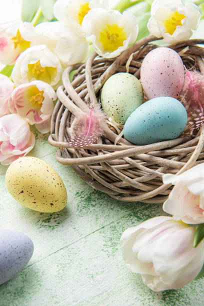 istock Nest with Easter eggs painted pastel colors on a green wooden background. 1467518996