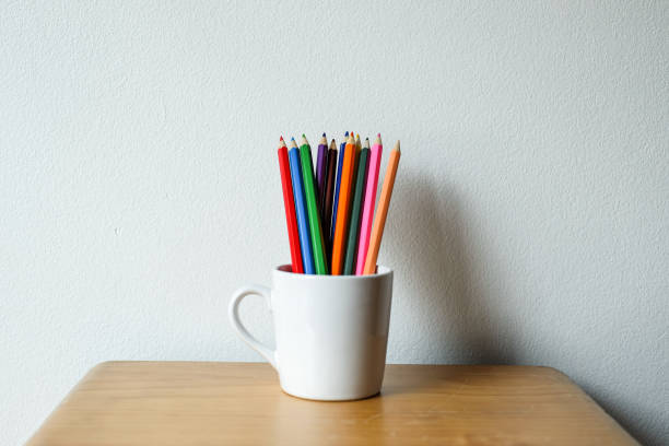 istock Stack of colored pencils in a glass on wooden background, Selective focus. 1467519744