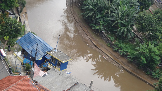 a flood pump house in Jakarta, the background of the Ciliwung River seen from above. dividing the city of Central Jakarta, Indonesia. photo taken 14 october 2022