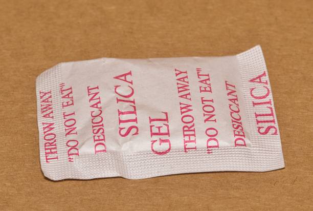 istock Single Silica gel packet isolated in a cardboard box, flat lay. 1467521966