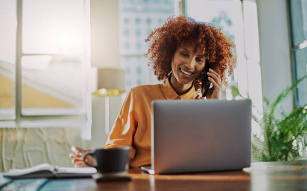 istock Phone call, cafe and black woman on laptop for remote work opportunity, networking or communication. Morning planning, talking on smartphone and USA person in coffee shop in morning discussion online 1467523637