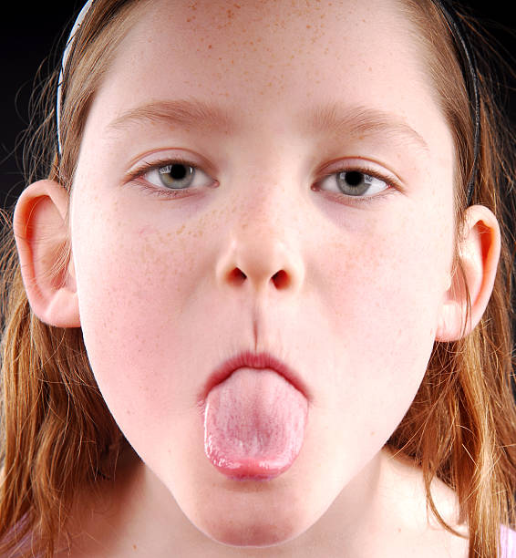 Little kid sticking out his tongue.