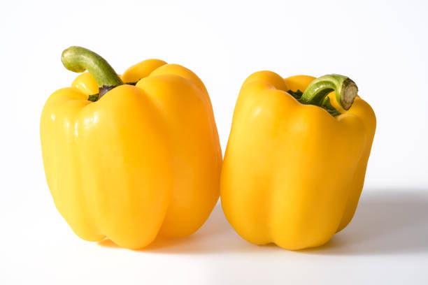 Yellow sweet bell pepper with water drops isolated on white background.