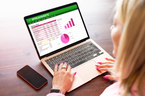 istock Woman working on spreadsheets on laptop 1467527778