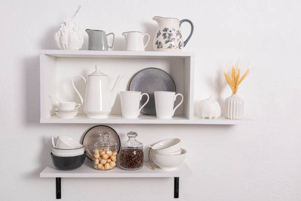 istock beautiful white shelves with kitchen utensils on a white textured wall. kitchen interior in white tones. front view. ecologically clean kitchen. 1467531504