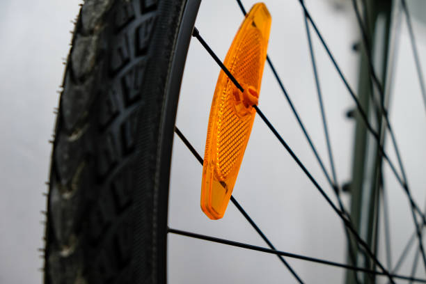 istock Bike reflector. A simple orange plastic cataphote on a bicycle wheel. 1467533593