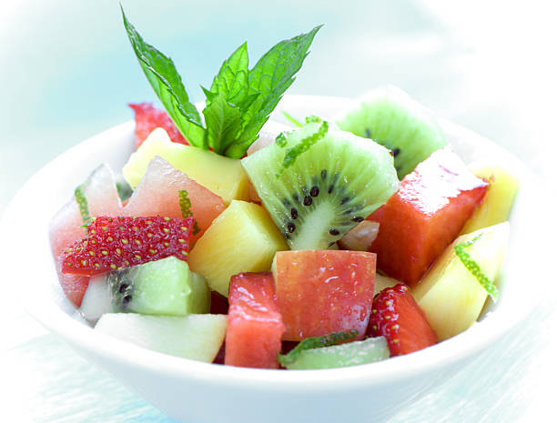 istock bowl of fruit salad on blue 146753372