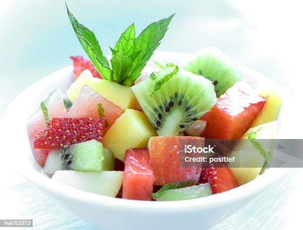 Bowl Of Fruit Salad On Blue Stock Photo - Download Image Now - Apple - Fruit, Bowl, Color Image