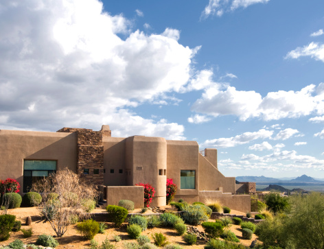 Beautiful Southwestern adobe style home located on a mountain with views of desert wilderness and mountains.