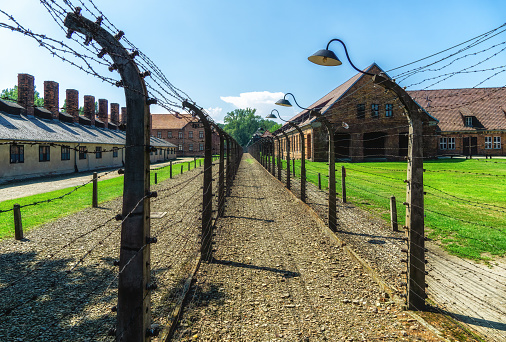 Auschwitz, Poland - November 15, 2019: Barbed wire fence at the Auschwitz concentration camp, the biggest extermination camp in Europe built by Nazi.