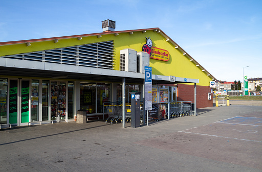 Skawina, Poland - March 27, 2022: Biedronka supermarket shop with brand logo sign. Retail chain of discount shops in Poland. Convenience grocery store, Polish shopping center.