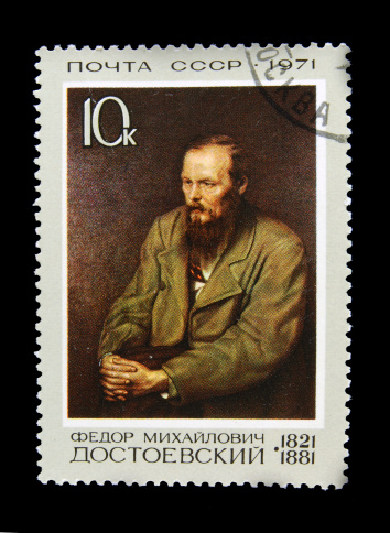 Old Russian postage stamp with Fyodor Dostoyevsky isolated on black background