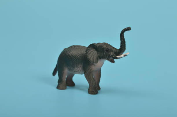 istock Black toy elephant isolated on a blue background 1467539231