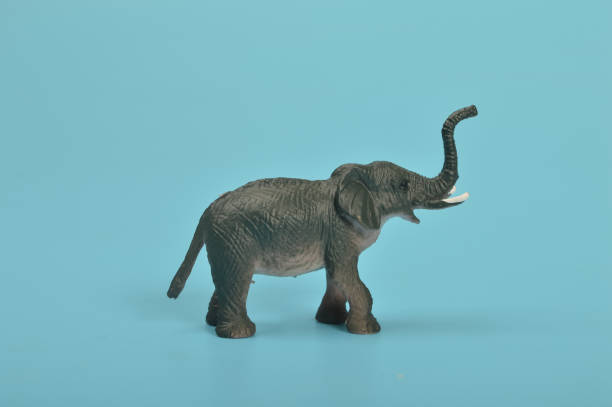 istock Black toy elephant isolated on a blue background. 1467539233