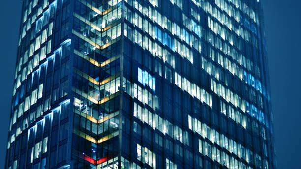istock Pattern of office buildings windows illuminated at night. 1467542620
