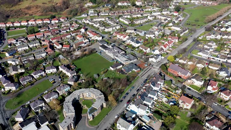 Aerial footage of the town of Deganwy in Conwy County Borough in Wales It lies in the Creuddyn Peninsula alongside Llandudno Rhos-on-Sea showing residential housing estates in the town.