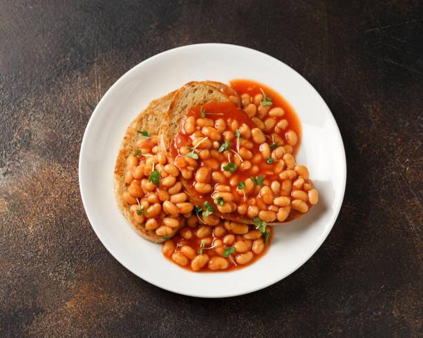 istock Baked beans on toast in tomato sauce on white plate 1467544490