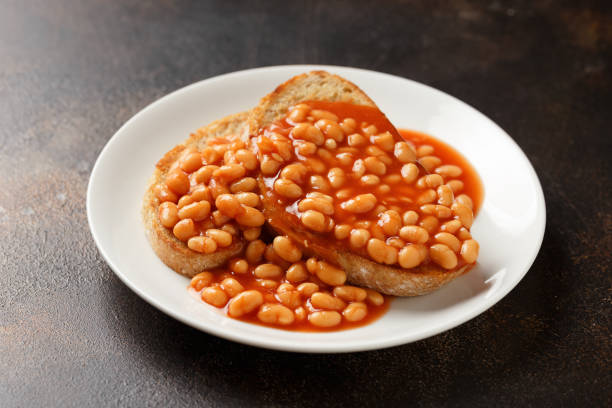 istock Baked beans on toast in tomato sauce on white plate 1467544492