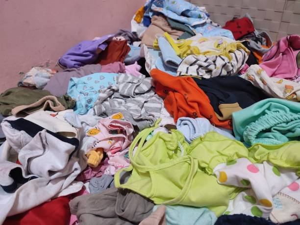 istock Messy children's clothes on the floor 1467544781