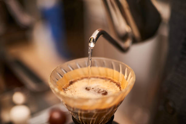 istock Young Asian barista brewing fresh ground coffee. 1467547348