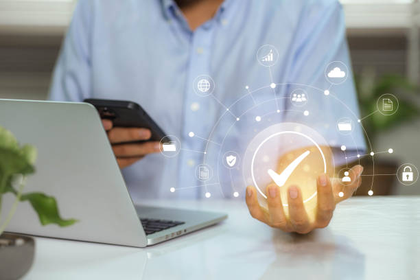 istock Businessman working on laptop with check mark symbol and standard quality control. The concept of international standards and quality assurance is certified 1467547992