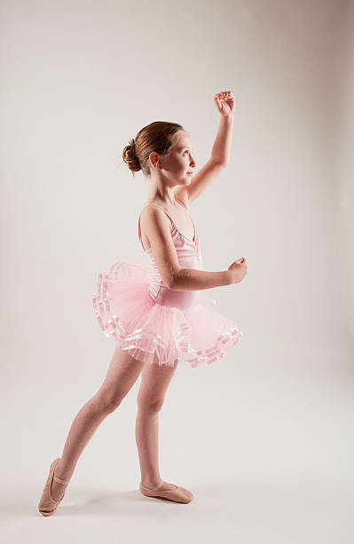 istock young girl practicing ballet in pink tutu 146754944