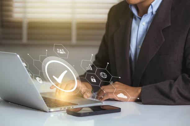 istock Businessman working on labtop with check mark symbol and standard quality control. The concept of international standards and quality assurance is certified 1467549459