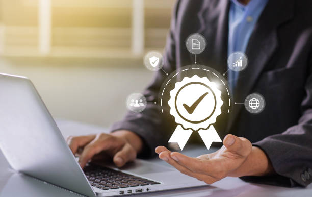 istock Businessman working on labtop with check mark symbol and standard quality control. The concept of international standards and quality assurance is certified 1467550978