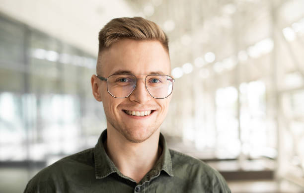 Portrait of handsome smiling young man looking at camera