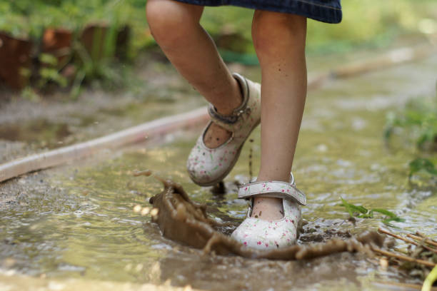 istock Childs feet in puddle 1467553942