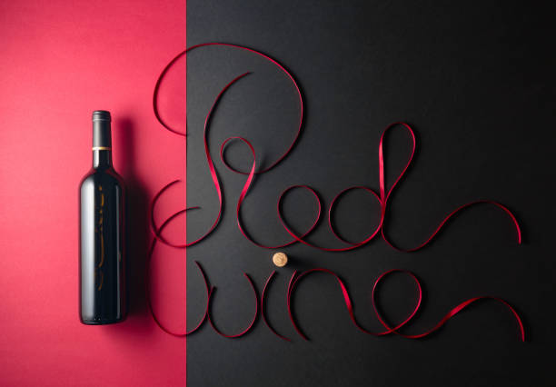 istock Bottle of red wine with red satin ribbons. 1467557404