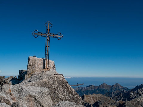 The peak of the highest mountain in Slovakia, Gerlachovsky Stit, on which a cross rises.