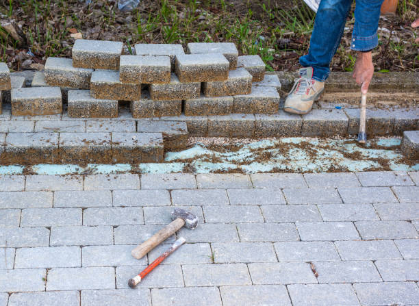 istock Making a track in the self-locking paving to bury an electrical cable. Dismantling some concrete slabs. 1467560632