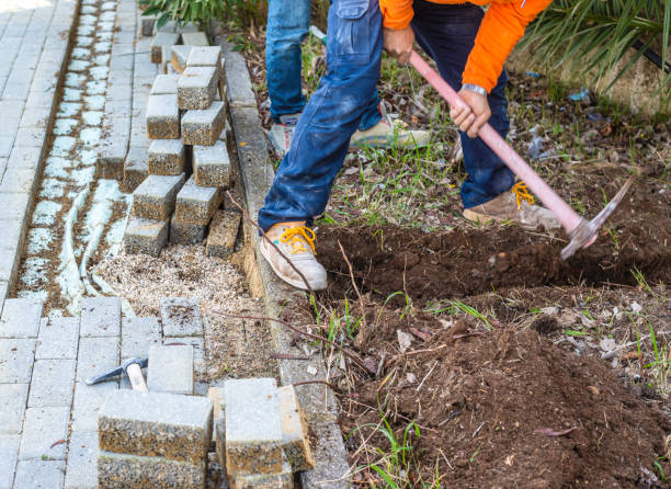 istock Making a track in the self-locking paving to bury an electrical cable. Dismantling some concrete slabs. 1467560781