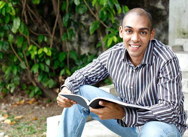 istock Asian student studying a book sitted by stairs 146756107