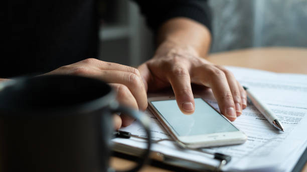 istock Close-up man using the phone on the table , mock-up screen 1467565816